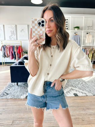 Natalie Sweater - Natural-Natalie Sweater - Natural | VerClare Boutique | Jenison MI-The Natalie Sweater is a light-weight, cotton/acrylic blend. Wood buttons, ribbed at end of sleeves and waist. The sweater is short sleeve but longer for extra coverage. Fits a bit oversized. Perfect by itself, with a cami/tank underneath. Great with shorts, jeans. Dress it up or down Staple in your wardrobe.. Free US shipping from VerClare Boutique.-VerClare Boutique