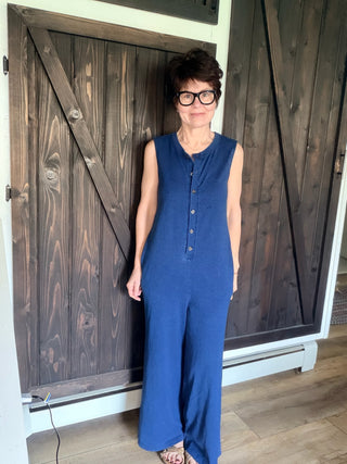 Fiona Jersey Denim Jumpsuit - Indigo-Dresses & RompersFiona Jersey Denim Jumpsuit - Indigo| VerClare Boutique | Jenison MI -The Z Supply Fiona Jersey Denim Jumpsuit is a beautiful cotton knit jersey sleeveless jumpsuit featuring a Henley-style button front, side seam pockets, and an easy relaxed silhouette. Free US shipping on eligible orders. -VerClare Boutique