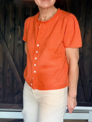 Rena Short Sleeve Sweater Cardigan - Orange-SweatersRena Short Sleeve Sweater Cardigan in Orange | VerClare Boutique-Shop the &merci Rena Short Sleeve Sweater Cardigan in Orange — puff shoulders, ribbed neck, button-down placket, semi-cropped fit. Sizes S–L. $59.99-VerClare Boutique