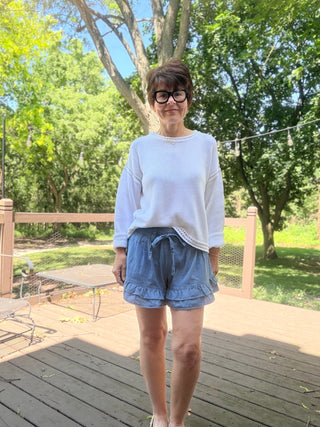 Flavia Ruffle Tiered Denim Shorts - Light Denim-BottomsEE:SOME Flavia Ruffle Tiered Denim Shorts - Light Denim | VerClare Boutique-Shop the EE:SOME Flavia Ruffle Tiered Denim Shorts in Light Denim. Cotton-blend denim, tiered ruffle design, drawstring waist, relaxed feminine fit. Sizes S–L.-VerClare Boutique