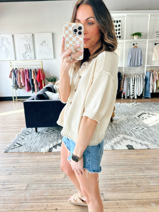 Natalie Sweater - Natural-Natalie Sweater - Natural | VerClare Boutique | Jenison MI-The Natalie Sweater is a light-weight, cotton/acrylic blend. Wood buttons, ribbed at end of sleeves and waist. The sweater is short sleeve but longer for extra coverage. Fits a bit oversized. Perfect by itself, with a cami/tank underneath. Great with shorts, jeans. Dress it up or down Staple in your wardrobe.. Free US shipping from VerClare Boutique.-VerClare Boutique