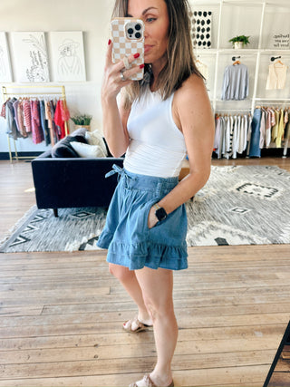 Flavia Ruffle Tiered Denim Shorts - Light Denim-BottomsFlavia Ruffle tiered Denim Shorts - Light Denim | VerClare Boutique | Jenison MI -Ruffle Tiered Denim Shorts are a beautiful soft denim woven ruffle-tiered short featuring a playful tiered ruffle design, a comfortable drawstring waistband, and a relaxed, feminine silhouette. Free US shipping from VerClare Boutique.-VerClare Boutique