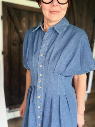 Galilea Pleated Denim Mini Dress - Denim-Dresses & RompersBelle Stripe Soft Brushed Top – Denim Blue Combo | VerClare Boutique | Jenison MI -This Pleated Denim Mini Dress is a beautiful structured denim woven button-front mini dress featuring a classic collared neckline, short dolman sleeves, and front and back pleat detailing that defines the waist. Free US shipping from VerClare Boutique.-VerClare Boutique