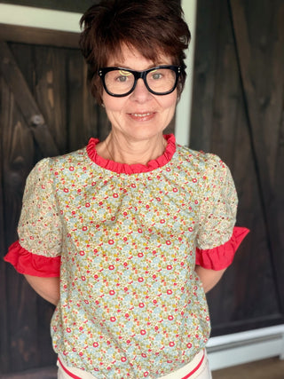 Gemma Contrast Ruffle Floral Embroidered Top-Tops CasualGemma Contrast ruffle Floral Embroidered Top | VerClare Boutique | Jenison MI-This is a beautiful floral print, round neckline, eyelet embroidered short puff sleeve, contrast colored solid ruffle detail, back neck button and loop closure and a striped elastic banded hem. Free US shipping from VerClare Boutique on eligible orders.-VerClare Boutique