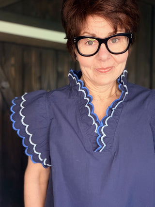 Bev Poplin Top - Navy-Tops CasualBev Poplin Top | VerClare Boutique | Jenison MI -This beautiful 100% cotton top features an embroidered scalloped v-neck with stand-up collar and embroidering around sleeves. The fit is oversized. Free US shipping on eligible orders. -VerClare Boutique