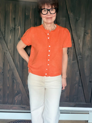 Rena Short Sleeve Sweater Cardigan - Orange-SweatersRena Short Sleeve Sweater Cardigan in Orange | VerClare Boutique-Shop the &merci Rena Short Sleeve Sweater Cardigan in Orange — puff shoulders, ribbed neck, button-down placket, semi-cropped fit. Sizes S–L. $59.99-VerClare Boutique
