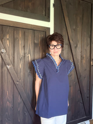 Bev Poplin Top - Navy-Tops CasualBev Poplin Top | VerClare Boutique | Jenison MI -This beautiful 100% cotton top features an embroidered scalloped v-neck with stand-up collar and embroidering around sleeves. The fit is oversized. Free US shipping on eligible orders. -VerClare Boutique