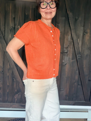 Rena Short Sleeve Sweater Cardigan - Orange-SweatersRena Short Sleeve Sweater Cardigan in Orange | VerClare Boutique-Shop the &merci Rena Short Sleeve Sweater Cardigan in Orange — puff shoulders, ribbed neck, button-down placket, semi-cropped fit. Sizes S–L. $59.99-VerClare Boutique