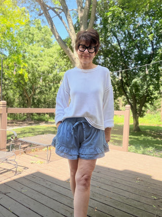 Flavia Ruffle Tiered Denim Shorts - Light Denim-BottomsEE:SOME Flavia Ruffle Tiered Denim Shorts - Light Denim | VerClare Boutique-Shop the EE:SOME Flavia Ruffle Tiered Denim Shorts in Light Denim. Cotton-blend denim, tiered ruffle design, drawstring waist, relaxed feminine fit. Sizes S–L.-VerClare Boutique