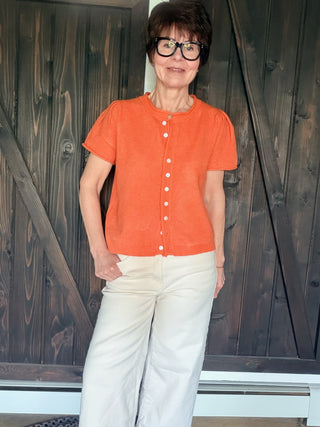 Rena Short Sleeve Sweater Cardigan - Orange-SweatersRena Short Sleeve Sweater Cardigan in Orange | VerClare Boutique-Shop the &merci Rena Short Sleeve Sweater Cardigan in Orange — puff shoulders, ribbed neck, button-down placket, semi-cropped fit. Sizes S–L. $59.99-VerClare Boutique