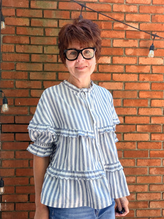 Nancy Stripe Tiered Blouse-TopsLovLov Nancy Stripe Tiered Blouse – Navy | VerClare Boutique-Shop the LovLov Nancy Stripe Tiered Blouse in navy — a delicate striped, tiered silhouette in a 50/50 cotton-poly blend. Feminine, lightweight, and effortlessly styled. Sizes S–XL.-VerClare Boutique