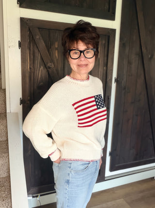 American Flag Sweater - White-SweatersAmerican Flag Sweater - White | VerClare Boutique | Jenison MI -Show your stripes — literally. The By Together American Flag Sweater in White is a fun, feel-good piece that brings a little patriotic spirit to your everyday wardrobe. Crafted in a soft knit with a classic American flag design, this sweater is casual enough for weekend wear but styled enough to make a statement. Free US shipping from VerClare Boutique on eligible orders.-VerClare Boutique