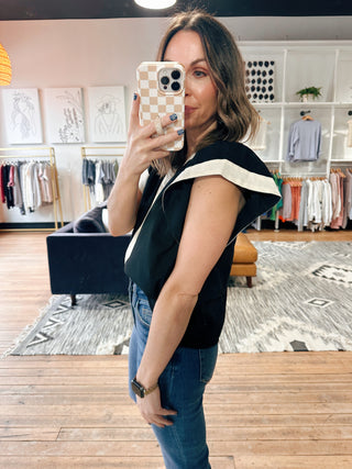 Amina Flutter Sleeve V-Neck Top - Black-Tops CasualAmina Flutter Sleeve V-Neck Top – Black | VerClare Boutique | Chenoa, IL-Chic black flutter sleeve V-neck top with a lightweight, flowy feel. Easy to dress up or down for everyday wear. Shop women’s boutique styles at VerClare Boutique.-VerClare Boutique