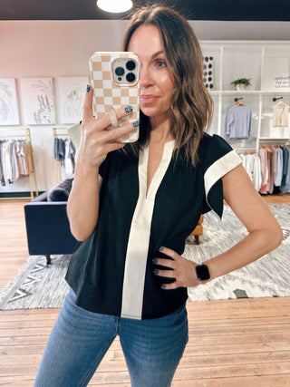 Amina Flutter Sleeve V-Neck Top - Black-Tops CasualAmina Flutter Sleeve V-Neck Top – Black | VerClare Boutique | Chenoa, IL-Chic black flutter sleeve V-neck top with a lightweight, flowy feel. Easy to dress up or down for everyday wear. Shop women’s boutique styles at VerClare Boutique.-VerClare Boutique
