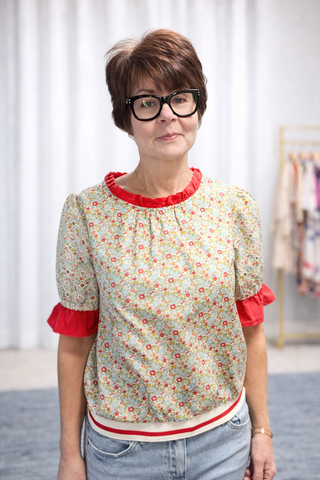 Gemma Contrast Ruffle Floral Embroidered Top-Tops CasualGemma Contrast ruffle Floral Embroidered Top | VerClare Boutique | Jenison MI-This is a beautiful floral print, round neckline, eyelet embroidered short puff sleeve, contrast colored solid ruffle detail, back neck button and loop closure and a striped elastic banded hem. Free US shipping from VerClare Boutique on eligible orders.-VerClare Boutique