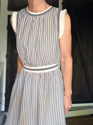 Shellie Ruffled Rib Band Dress-Dresses & RompersShellie Ruffled Rib Band Dress – Slater Blue | Voy – VerClare Boutique-Shop the Voy Shellie Ruffled Rib Band Dress in Slater Blue. 60% cotton 40% polyester, round neck, sleeveless, pockets, ruffle band, flared skirt, true to size. Sizes S–L.-VerClare Boutique