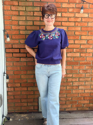 Scarlette Multi Color Embroidery Top - Navy-Tops Basic SolidVOY Scarlette Multi Color Embroidery Top - Navy | VerClare Boutique-Shop the VOY Scarlette Multi Color Embroidery Top in Navy. Soft knit, multicolor floral embroidery, scallop trim, round neck, feminine silhouette. Sizes S–L.-VerClare Boutique