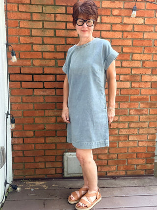 Paola Denim Back Button Dress - Denim Blue-Dresses & RompersSHE + SKY Paola Denim Back Button Mini Dress - Denim Blue | VerClare Boutique-Shop the SHE + SKY Paola Denim Back Button Dress in Denim Blue. Washed denim, drop sleeves, back button detail, pockets, mini length. Sizes S–L.-VerClare Boutique