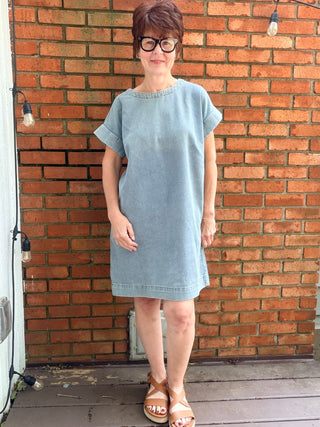 Paola Denim Back Button Dress - Denim Blue-Dresses & RompersSHE + SKY Paola Denim Back Button Mini Dress - Denim Blue | VerClare Boutique-Shop the SHE + SKY Paola Denim Back Button Dress in Denim Blue. Washed denim, drop sleeves, back button detail, pockets, mini length. Sizes S–L.-VerClare Boutique
