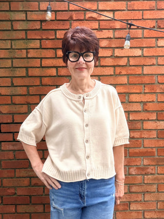 Natalie Sweater - Natural-The Workshop Natalie Sweater - Natural | VerClare Boutique-Shop the Natalie Sweater in Natural. Lightweight cotton/acrylic blend, wood buttons, ribbed cuffs and waist, short sleeve, oversized fit. Sizes S–L.-VerClare Boutique