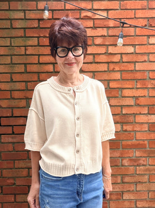Natalie Sweater - Natural-The Workshop Natalie Sweater - Natural | VerClare Boutique-Shop the Natalie Sweater in Natural. Lightweight cotton/acrylic blend, wood buttons, ribbed cuffs and waist, short sleeve, oversized fit. Sizes S–L.-VerClare Boutique