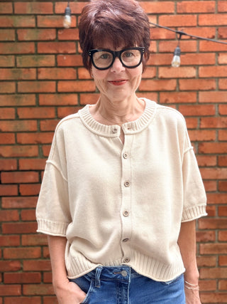 Natalie Sweater - Natural-The Workshop Natalie Sweater - Natural | VerClare Boutique-Shop the Natalie Sweater in Natural. Lightweight cotton/acrylic blend, wood buttons, ribbed cuffs and waist, short sleeve, oversized fit. Sizes S–L.-VerClare Boutique