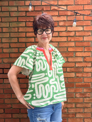 Tiana Pattern V-Neck Top - Green-Tops CasualTiana Pattern V-Neck Top – Green | THML – VerClare Boutique-Shop the THML Tiana Pattern V-Neck Top in Green. Rayon-nylon woven, V-neck, short sleeves, flowy patterned silhouette, true-to-size fit. Sizes XS–L.-VerClare Boutique