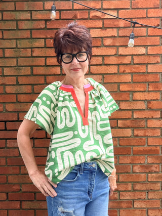 Tiana Pattern V-Neck Top - Green-Tops CasualTiana Pattern V-Neck Top – Green | THML – VerClare Boutique-Shop the THML Tiana Pattern V-Neck Top in Green. Rayon-nylon woven, V-neck, short sleeves, flowy patterned silhouette, true-to-size fit. Sizes XS–L.-VerClare Boutique