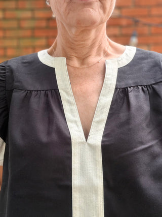 Amina Flutter Sleeve V-Neck Top - Black-Tops CasualAmina Flutter Sleeve V-Neck Top – Black | THML – VerClare Boutique-Shop the THML Amina Flutter Sleeve V-Neck Top in Black. Linen-viscose blend, flutter sleeves, contrast trim, V-neck, true-to-size fit. Sizes XS–L.-VerClare Boutique