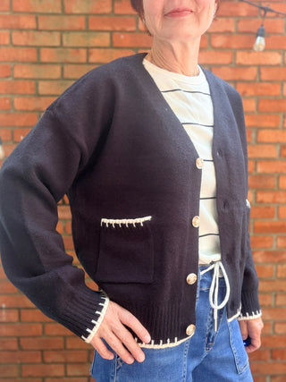 Skylar Cardigan-SweatersSkylar Cardigan | Black Whipstitch Button-Front Knit – EE:Some | VerClare Boutique-Shop the EE:Some Skylar Cardigan in black — ivory whipstitch trim, button-front, front pockets, relaxed fit. Sizes S–L. Ships fast from VerClare Boutique.-VerClare Boutique
