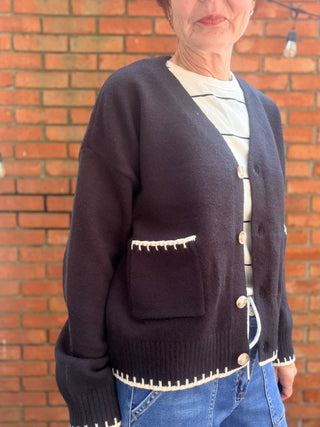 Skylar Cardigan-SweatersSkylar Cardigan | Black Whipstitch Button-Front Knit – EE:Some | VerClare Boutique-Shop the EE:Some Skylar Cardigan in black — ivory whipstitch trim, button-front, front pockets, relaxed fit. Sizes S–L. Ships fast from VerClare Boutique.-VerClare Boutique