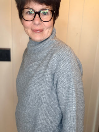 Lexi Waffle Knit Turtleneck Sweater-SweatersGrey Waffle Knit Turtleneck Sweater | VerClare Boutique-Shop the Lexi grey waffle knit turtleneck sweater, a cozy textured layer made with 50% recycled cotton. Available in sizes S/M and M/L.-VerClare Boutique