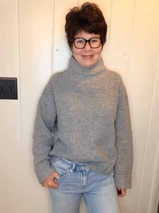 Lexi Waffle Knit Turtleneck Sweater-SweatersGrey Waffle Knit Turtleneck Sweater | VerClare Boutique-Shop the Lexi grey waffle knit turtleneck sweater, a cozy textured layer made with 50% recycled cotton. Available in sizes S/M and M/L.-VerClare Boutique