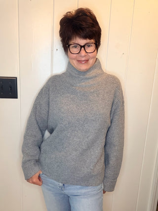 Lexi Waffle Knit Turtleneck Sweater-SweatersGrey Waffle Knit Turtleneck Sweater | VerClare Boutique-Shop the Lexi grey waffle knit turtleneck sweater, a cozy textured layer made with 50% recycled cotton. Available in sizes S/M and M/L.-VerClare Boutique