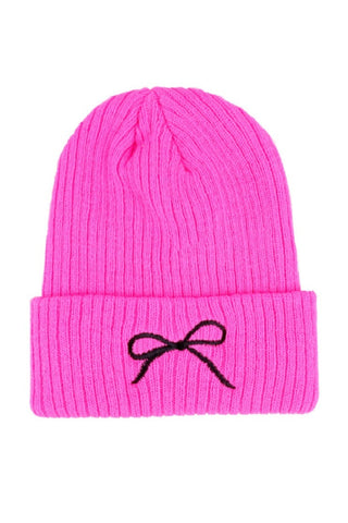 Hot pink beanie with a black bow on a white background