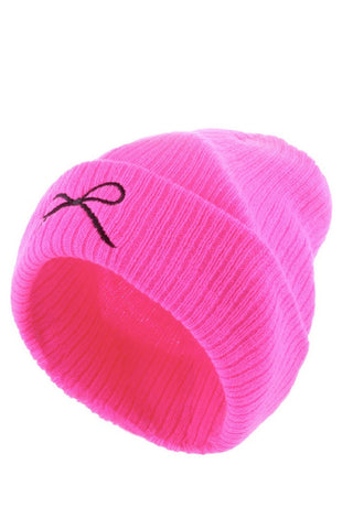 Hot pink beanie with a black bow on a white background